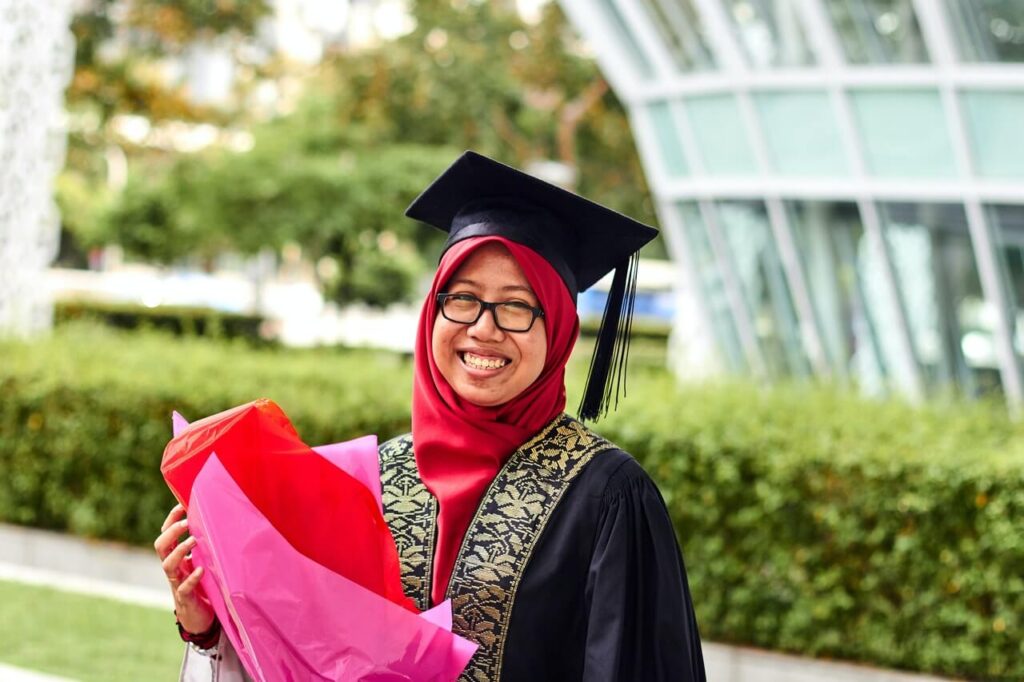 Malaysian woman in her graduation robe.