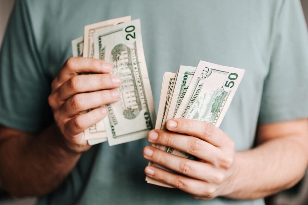 Student counting money he needs to attend universities in Malaysia.