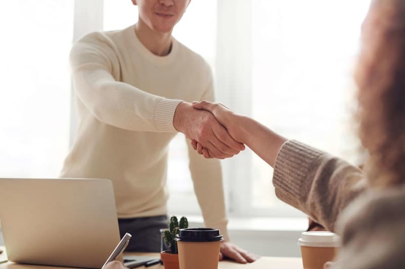 A man accepting job offers from employee after studying abroad. 