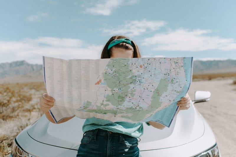 A girl planning her travels with a map while studying abroad. 